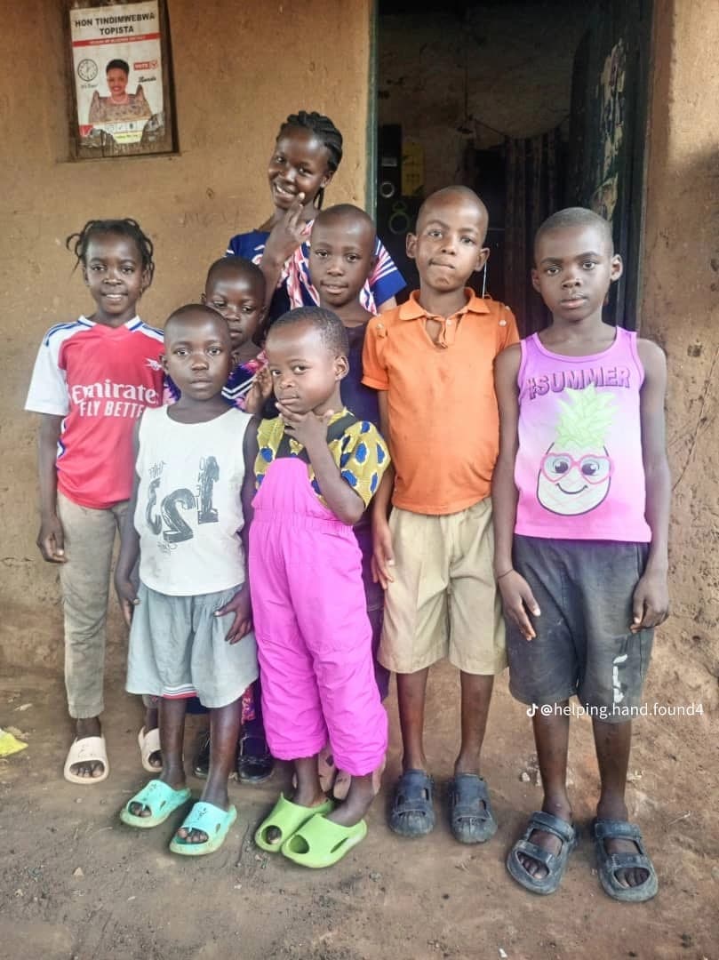Children of Mubende District standing together outside a home